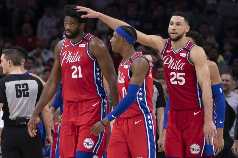 PHILADELPHIA, PA - FEBRUARY 11: Joel Embiid #21, Josh Richardson #0, and Ben Simmons #25 of the Philadelphia 76ers react against the Los Angeles Clippers at the Wells Fargo Center on February 11, 2020 in Philadelphia, Pennsylvania. The 76ers defeated the 